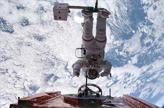 Foale attached to the RMS arm on the Space Shuttle Discovery's payload 